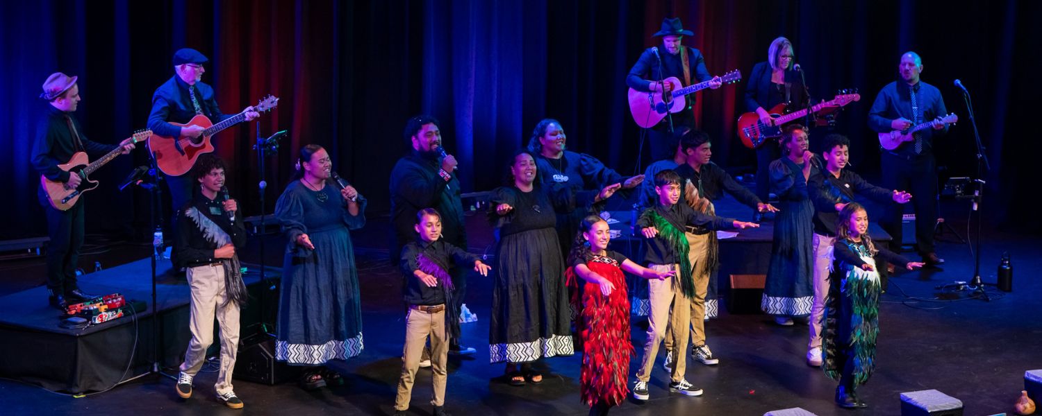 Community performers and musicians on stage at Baycourt.