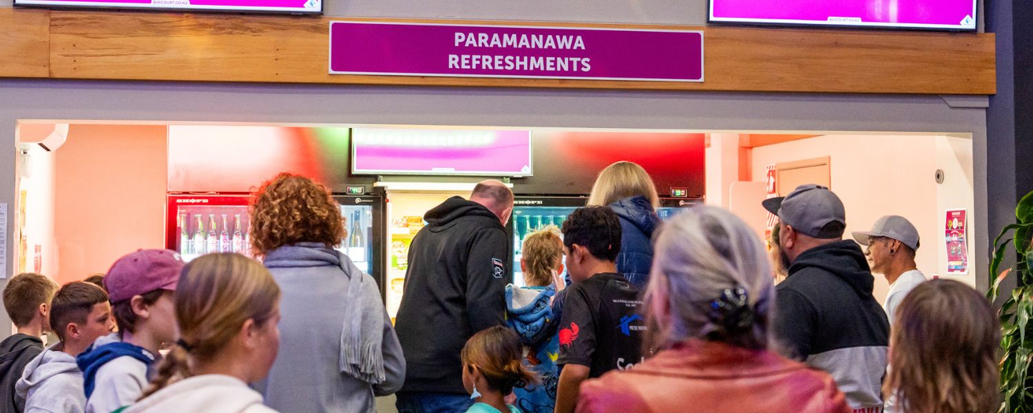 Baycourt patrons purchasing food and drinks at the refreshment bar.
