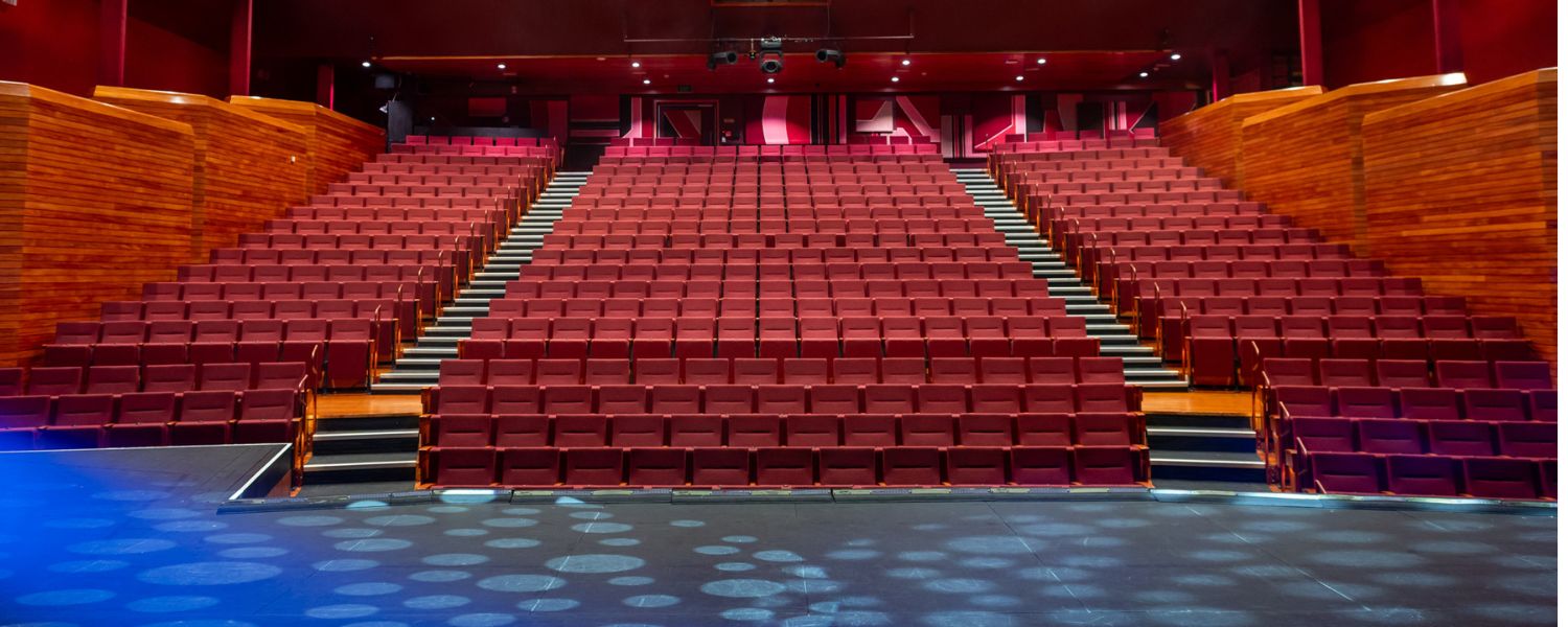Addison Theatre's 582 seat tiered auditorium viewed from the stage.